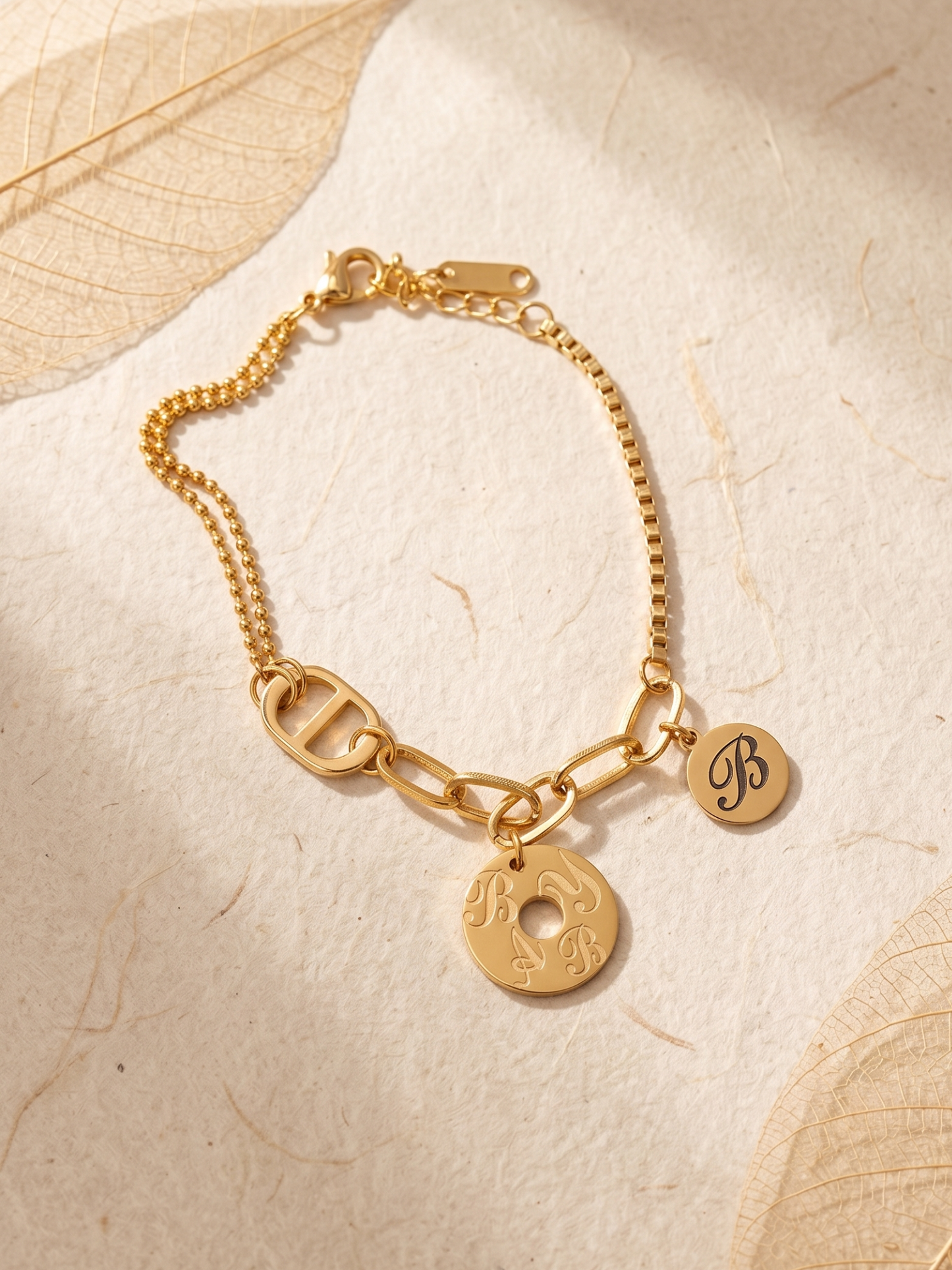 Gold bracelet with engraved charms