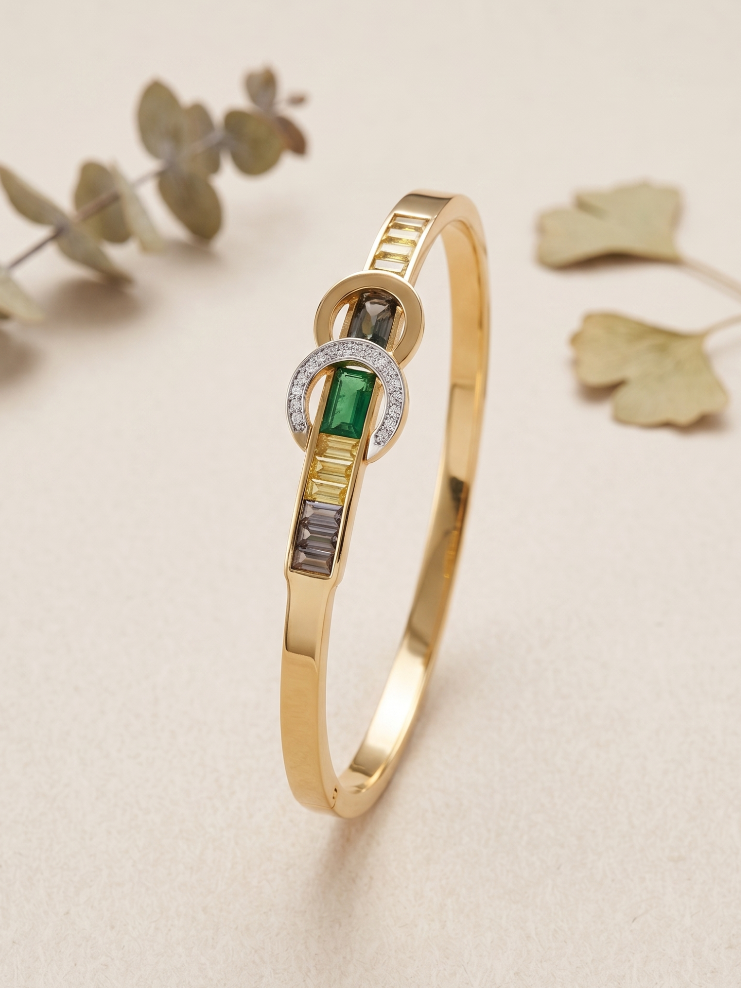 Gold bracelet with green gemstone and diamond accents