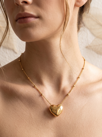 Gold lookalike heart-shaped pendant necklace on a light background