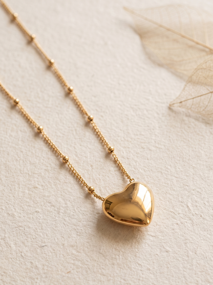 Gold lookalike heart-shaped pendant necklace on a light background