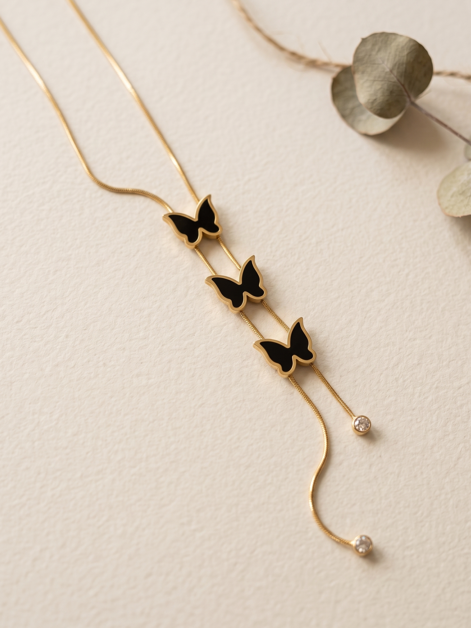 Gold necklace with butterfly pendants