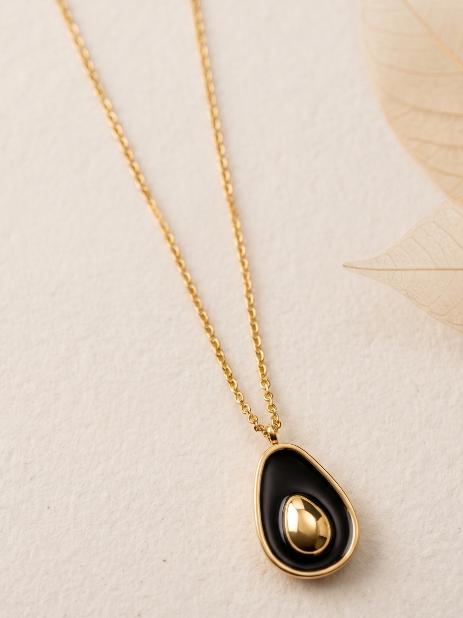 Necklace with a black teardrop pendant