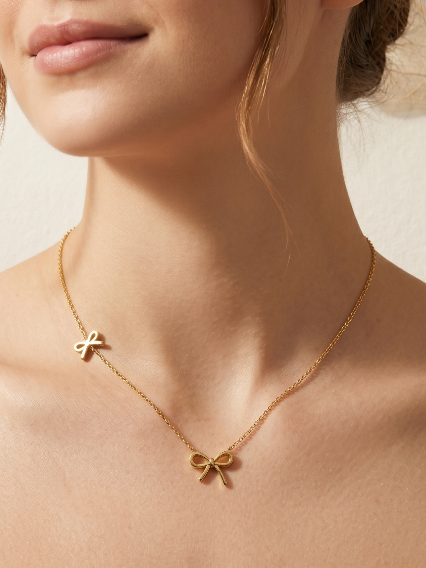 Gold necklace with two bow pendants 