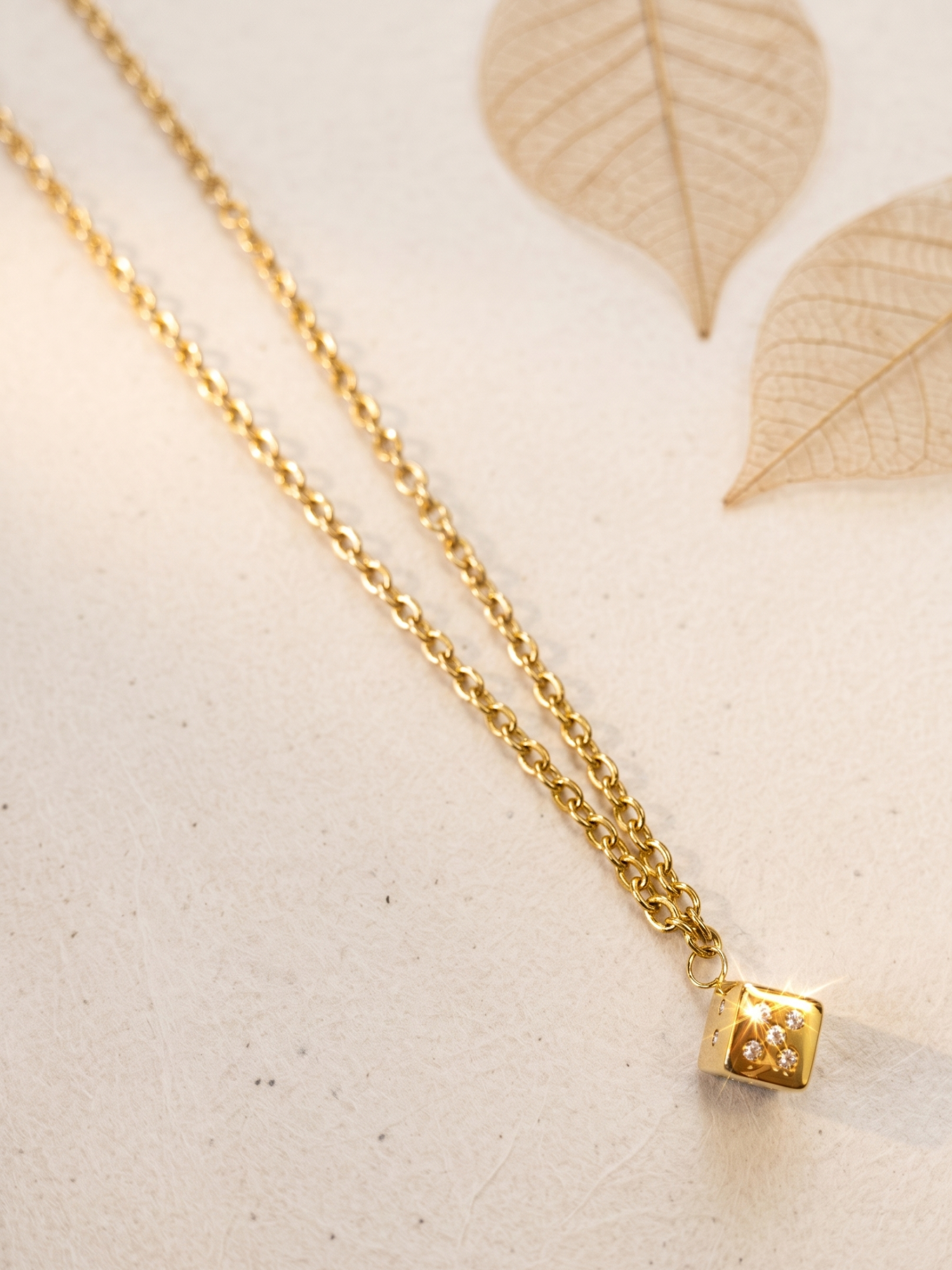 necklace with a cube pendant .