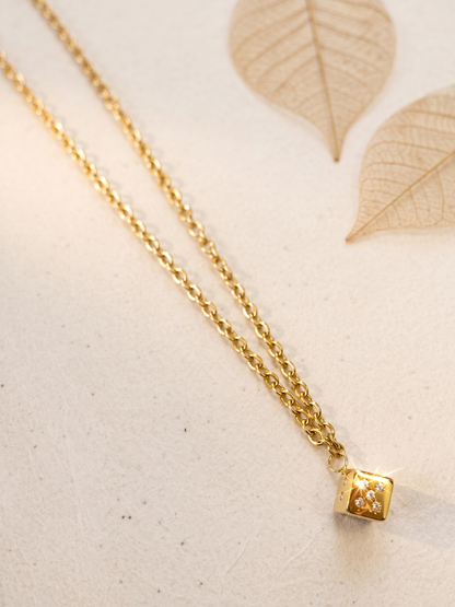 necklace with a cube pendant .