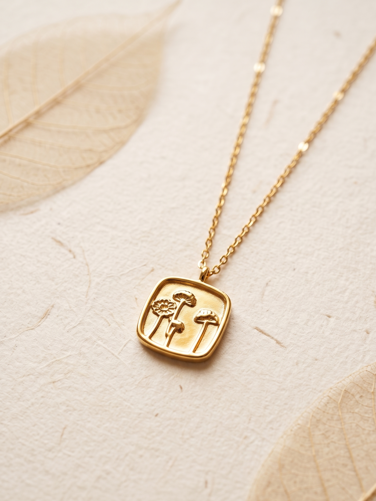 tarnish free necklace with a square pendant featuring floral designs 