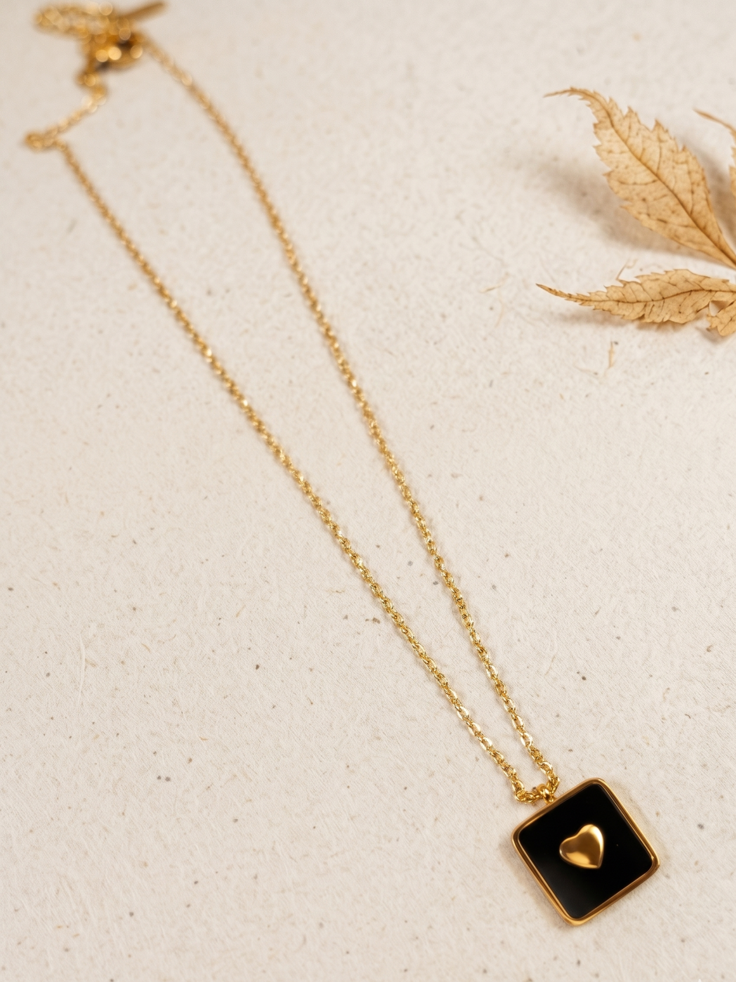 waterproof necklace with a black square pendant featuring a heart 