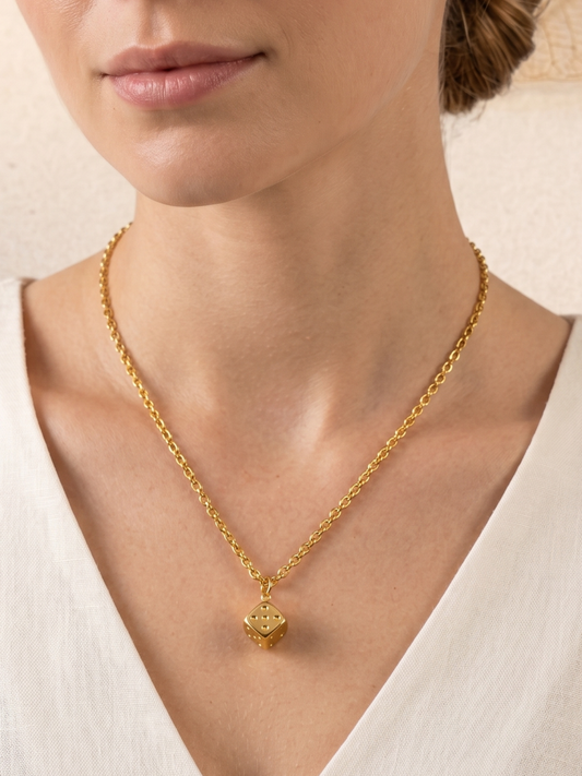 necklace with a cube pendant .